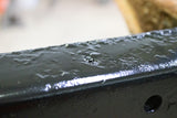 Close up look at Rust Buster Rust Converter & Primer Spray Paint RB9917 sprayed onto a piece of frame rail