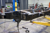 Wide angle, side view of the Rust Buster Rear Cab Mount For 2009-2014 Ford F-150 RB7019 installed to the frame rail