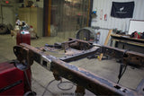 Side view, wide angle of the Rust Buster Forward Spare Tire Crossmember For 2009-2014 Ford F-150 RB7023 installed to the frame