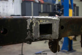 Exterior weld plate binding the Rust Buster Forward Spare Tire Crossmember For 2009-2014 Ford F-150 RB7023 to the frame rail