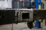 Exterior weld plate binding the Rust Buster Forward Spare Tire Crossmember For 2009-2014 Ford F-150 RB7023 to the frame rail