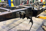Side view of the Rust Buster Rear Shock Mount For 2009-2014 Ford F-150 RB7027 installed to the frame rail