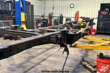 Wide angle of the Rust Buster Rear Shock Mount For 2009-2014 Ford F-150 RB7027 installed to the frame rail