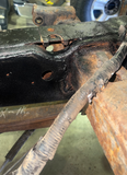 Professional installing the over axle frame section replacement for improved structural durability.