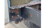 Close-up shot of Rust Buster Rear Frame Crossmember For 1999-2013 GM Pickups RB7331, welded to the left side of the vehicle's frame
