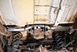 Wide angle of Rust Buster Fuel Tank Crossmember For 2000-2014 GM SUV's RB7412 installed to the frame rail