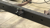 OE replacement body mount securely welded in place, providing essential support for the vehicle's body structure.