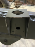 Professional installing the rear cab mount for improved structural support.