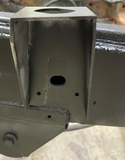 Professional installing the rear cab mount for improved structural support.