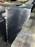 Professional installing the rear cab mount for improved structural support.