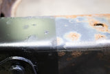 A piece of frame rail, with the left side sporting Rust Buster Rust Converter & Primer Spray Paint RB9917 and the right side having not been treated at all.