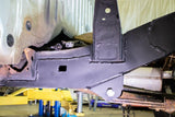 Rust Buster Mid-Frame Section with Leaf Spring Mount for 1995-2004 Toyota Tacoma, features drain hole and new leaf spring bolt, enhancing frame stability and ride comfort.